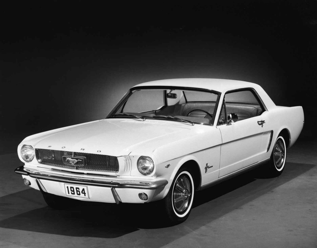 A white 1964 Ford Mustang parked in left front angle view