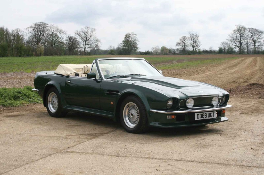 A green 1987 Aston Martin Vantage Volante convertible parked at a right front angle