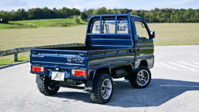A blue 1993 Honda Acty kei pickup truck shown parked at right rear angle