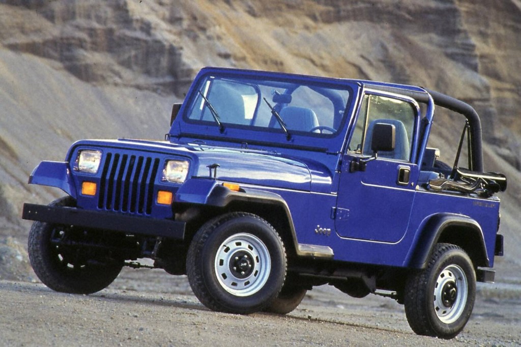 A blue 1994 Jeep Wrangler YJ shows off its styling and blue paintwork.