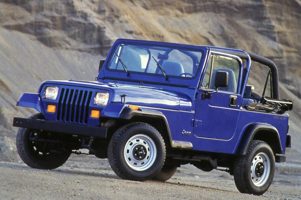 A blue 1994 Jeep Wrangler YJ shows off its styling and blue paintwork. 