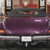 The trunk of a purple Plymouth Prowler parked in a garage.
