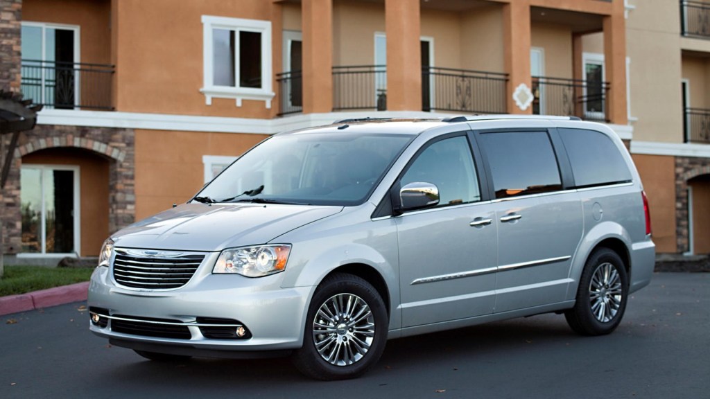 2012 Chrysler Town & Country minivan posed in front of a building.
