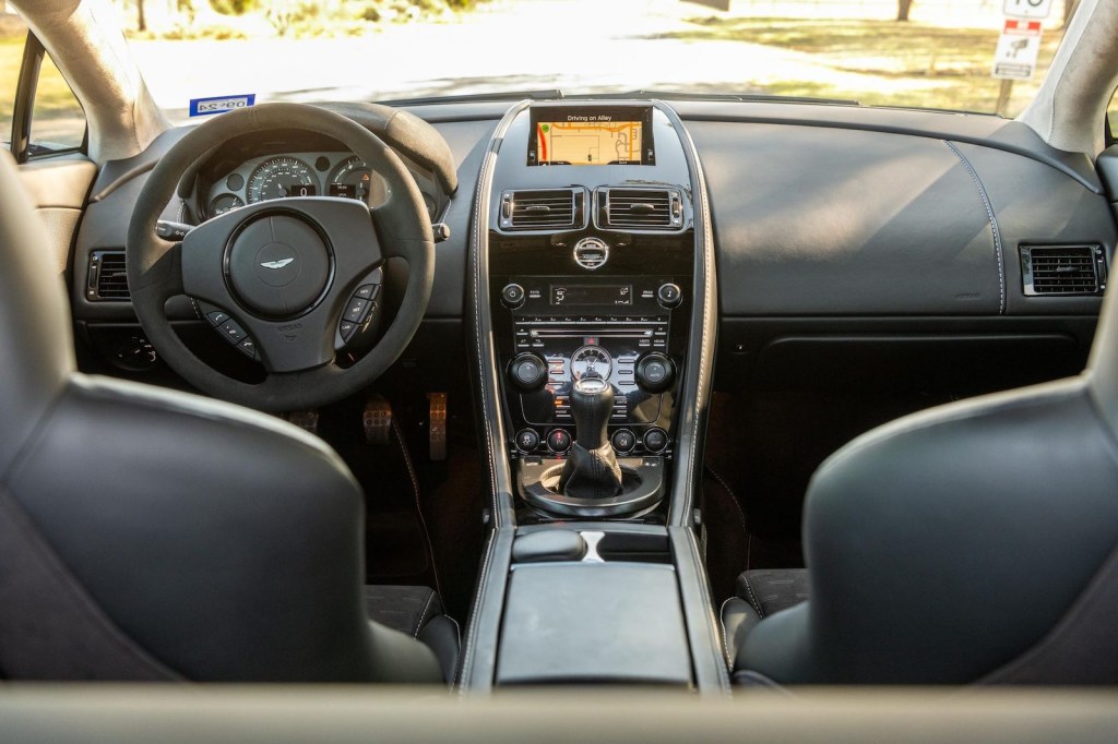 The interior of a stick shift Aston Martin V8  Vantage exotic car.