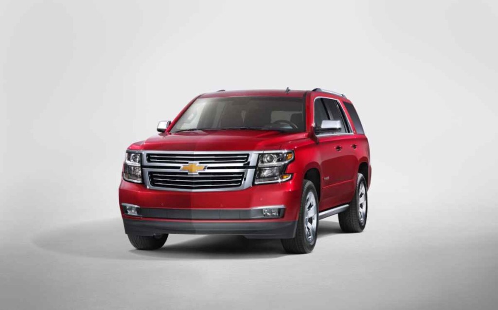 A red 2015 Chevrolet Tahoe is shown at left front angle view