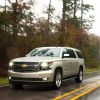 2016 Chevrolet Suburban driving down the highway.