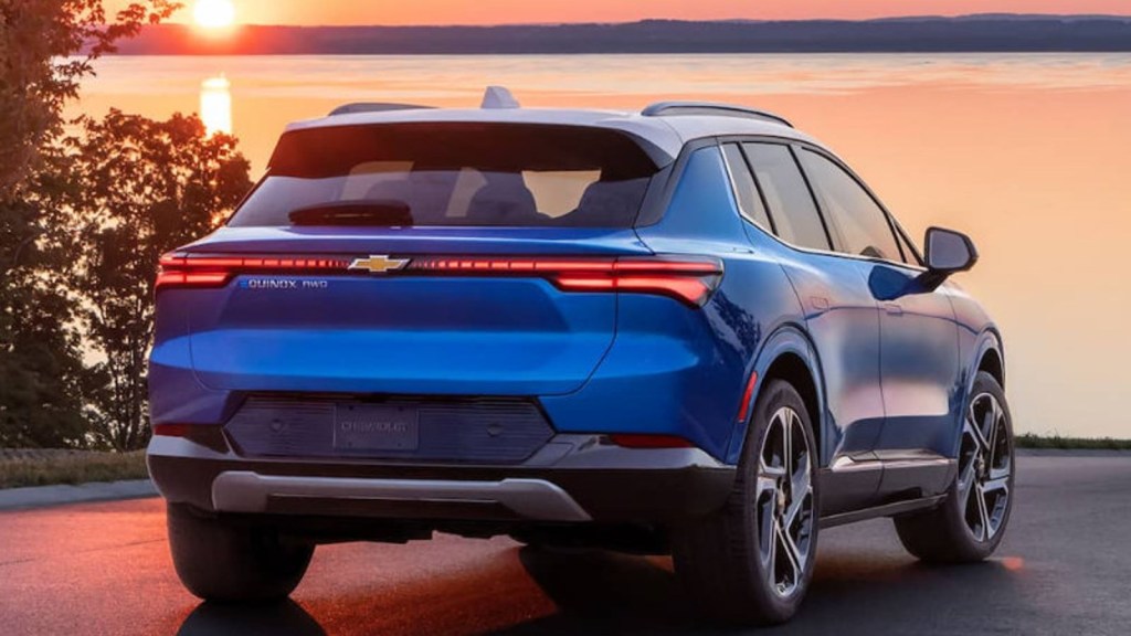 Rear view of a 2024 Chevy Equinox EV  with a sunset background.