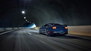 A 2024 Ford Mustang Dark Horse Handling Pack drives through a tunnel.