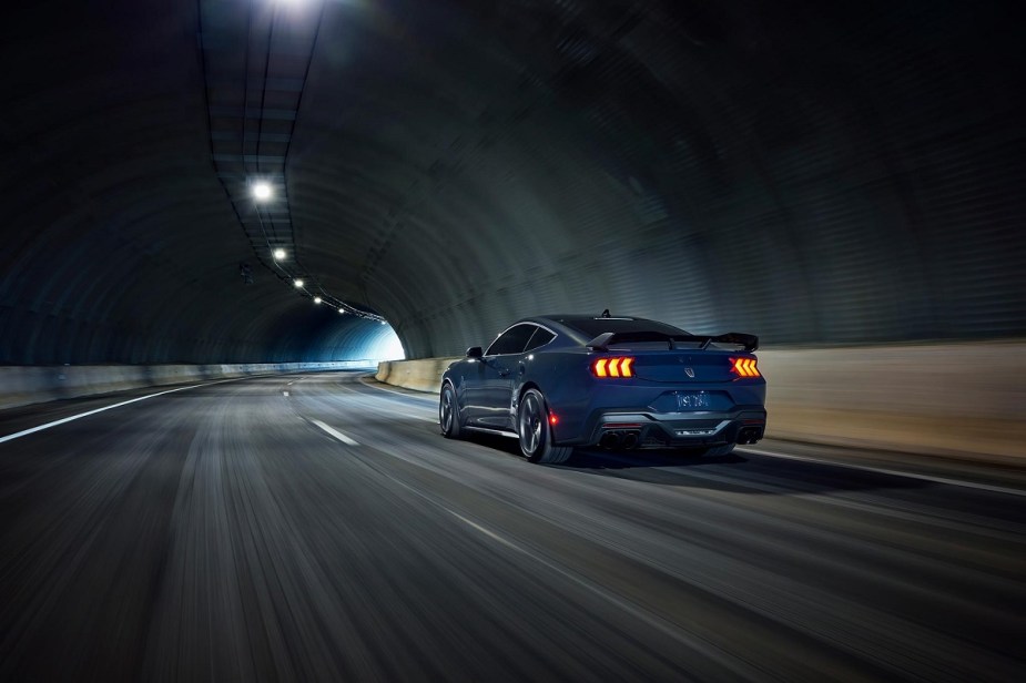 A 2024 Ford Mustang Dark Horse Handling Pack drives through a tunnel.