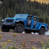 The 2024 Jeep Gladiator off-roading in the woods