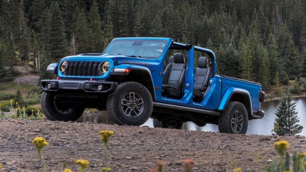 The 2024 Jeep Gladiator off-roading in the woods
