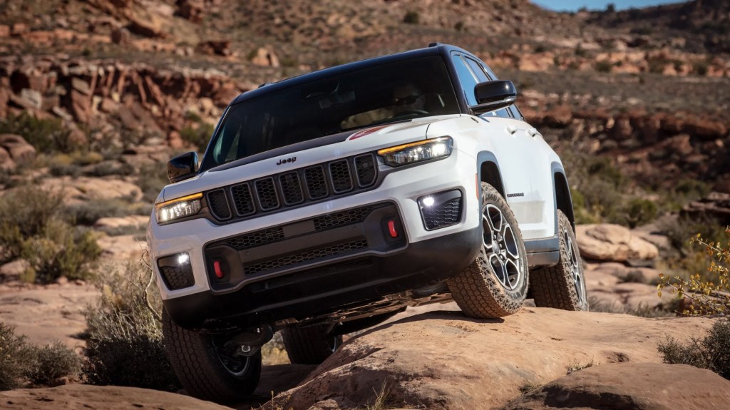 The 2024 Jeep Grand Cherokee climbing over rocks