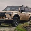 Gold colored 2024 Lexus GX luxury SUV posed on an off-road trail.