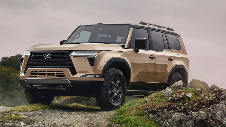 Gold colored 2024 Lexus GX luxury SUV posed on an off-road trail.
