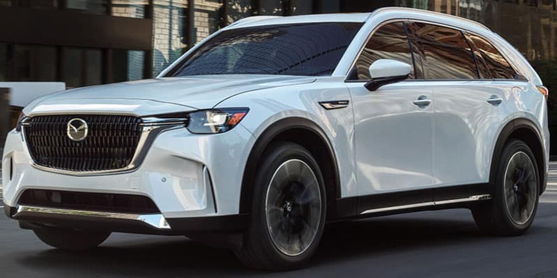 White 2024 Mazda CX-90 PHEV midsize SUV posed.