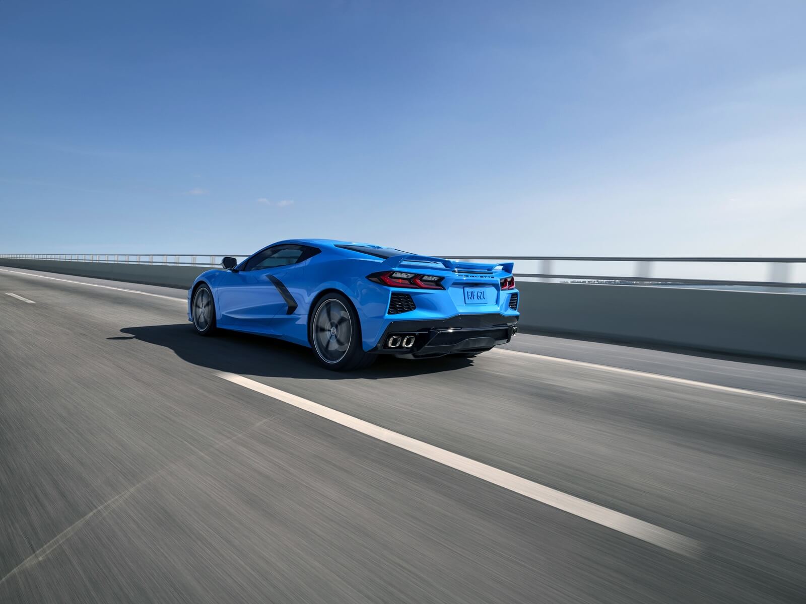 A blue 2024 Chevrolet Corvette C8 cruises without a manual transmission.