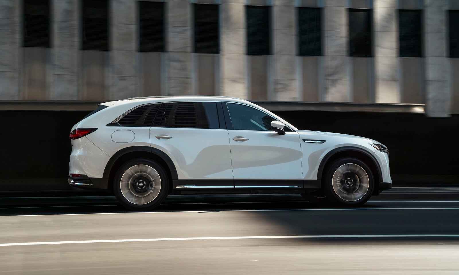 A full right side profile view of a white Mazda CX-90 PHEV SUV