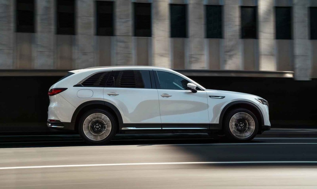 A full right side profile view of a white Mazda CX-90 PHEV SUV