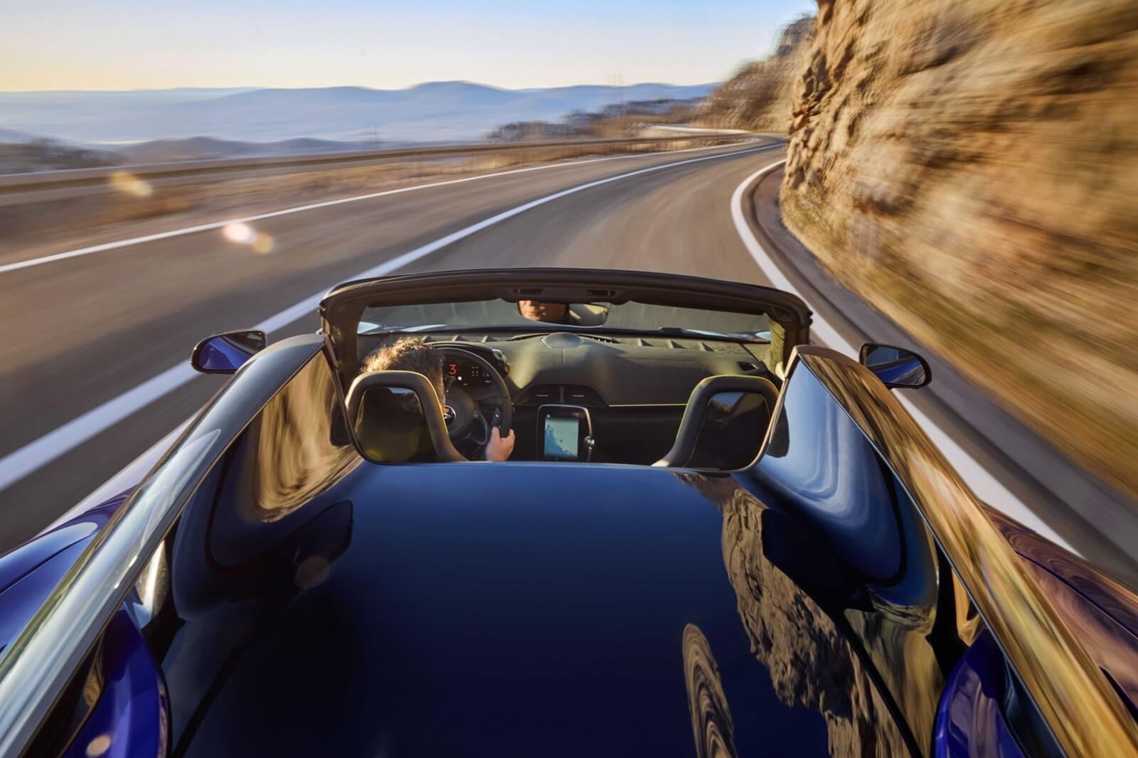 A blue McLaren shows off its drop-top platform.