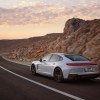 A 2025 Porsche Panamera 4S E-Hybrid shows off its rear-end styling in the desert.
