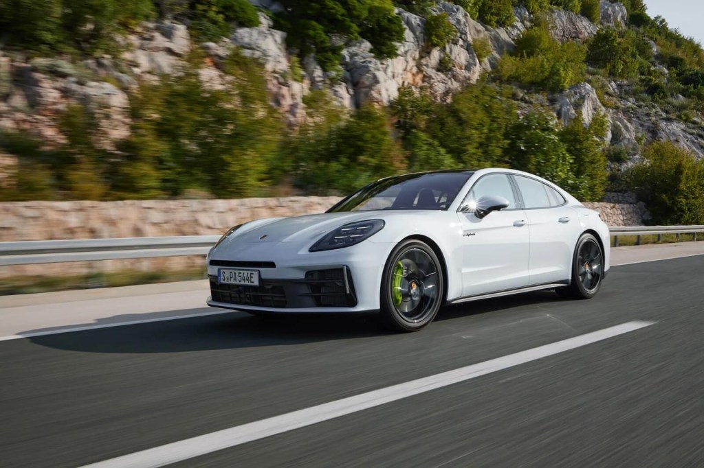 A 2025 Porsche Panamera Hybrid cruises on an empty highway. 