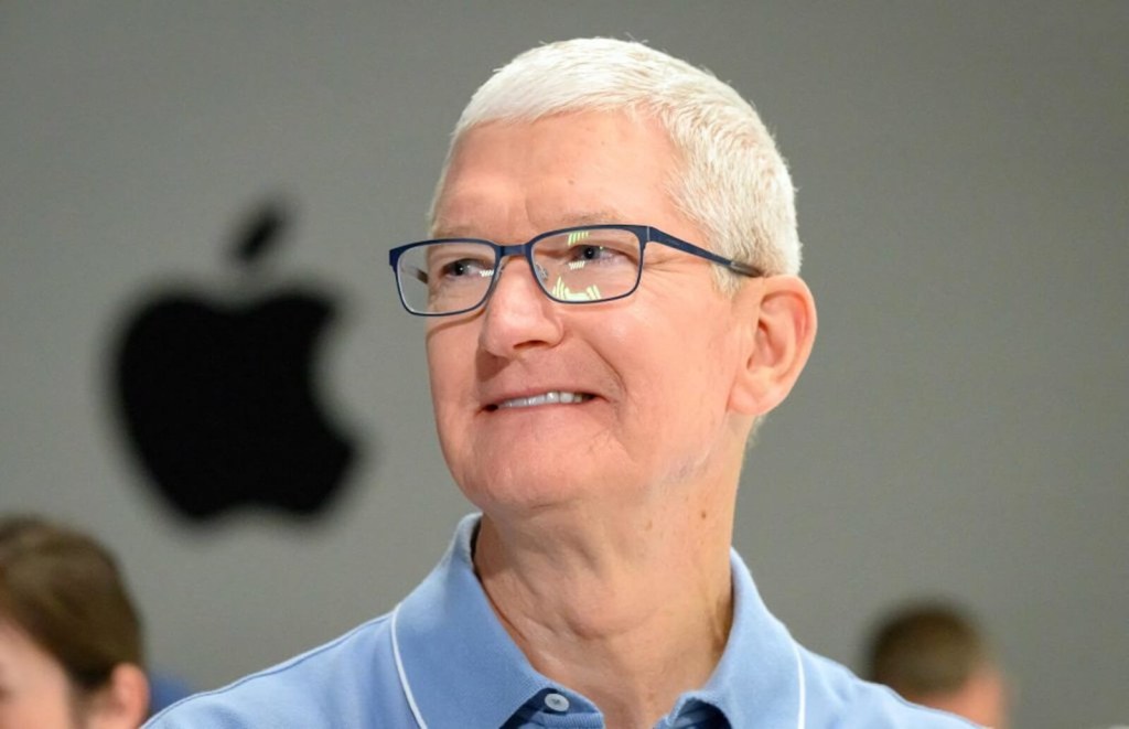 Apple CEO Tim Cook smiles at a media event. 