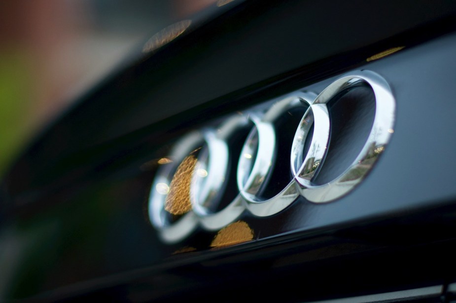 Audi's four-ring logo on the grille of a car.