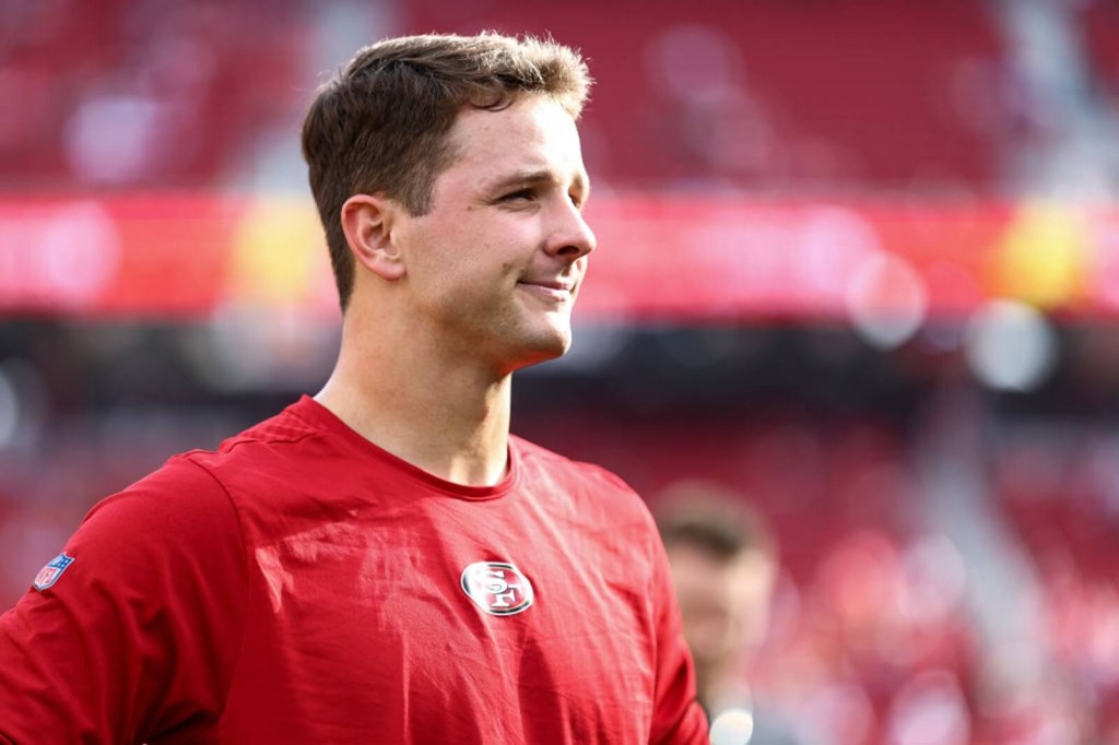 San Francisco 49ers QB Brock Purdy, a Toyota partner, smiles on the field. 