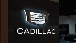 Light-up Cadillac logo and sign at a dealership.