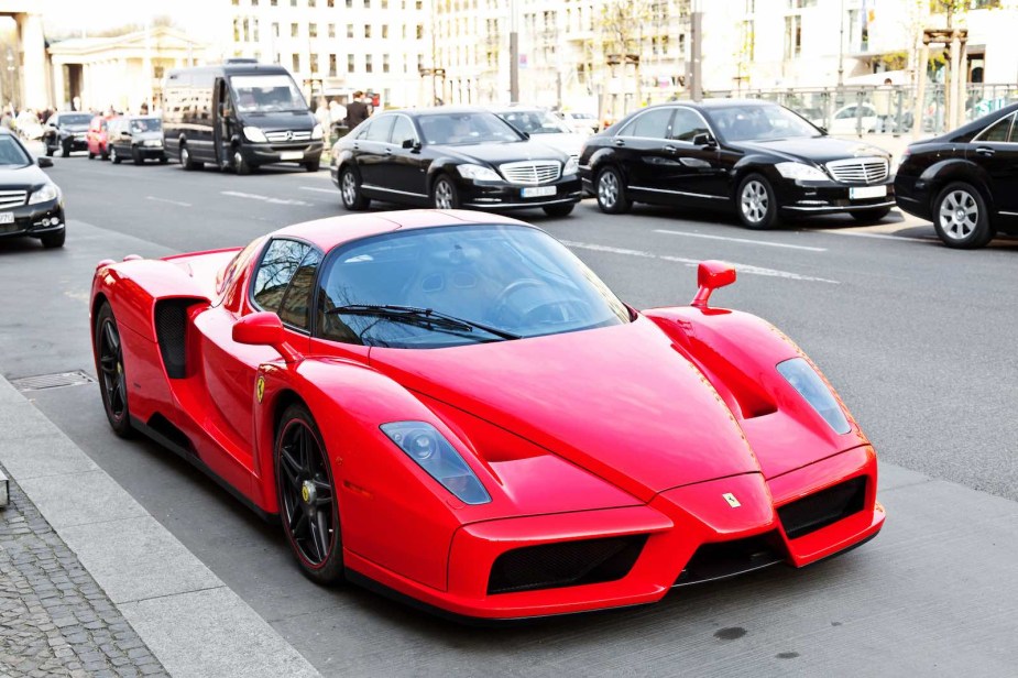 Red Ferrari Enzo supercar parked on the street.