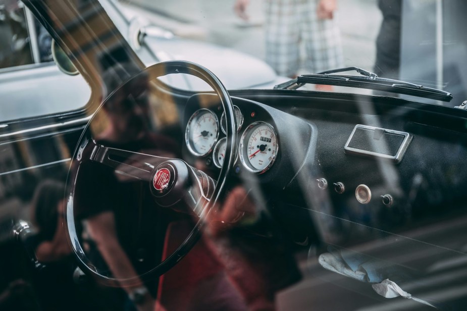 Fiat logo on the steering wheel of a classic car.