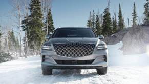Front View 2024 Genesis GV80 midsize luxury SUV on a snow-covered road.