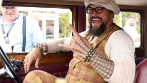 Jason Momoa flashes a big smile in a classic Rolls-Royce at the Goodwood Festival of Speed.