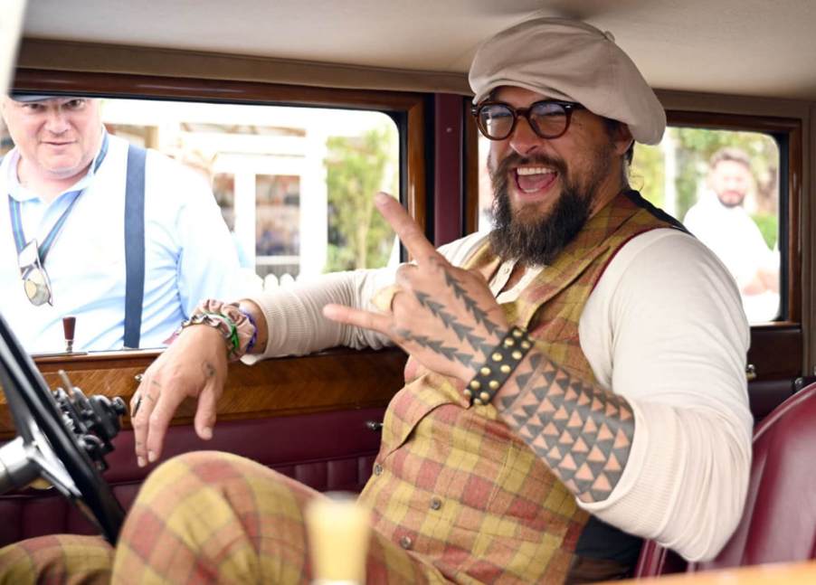Jason Momoa flashes a big smile in a classic Rolls-Royce at the Goodwood Festival of Speed.