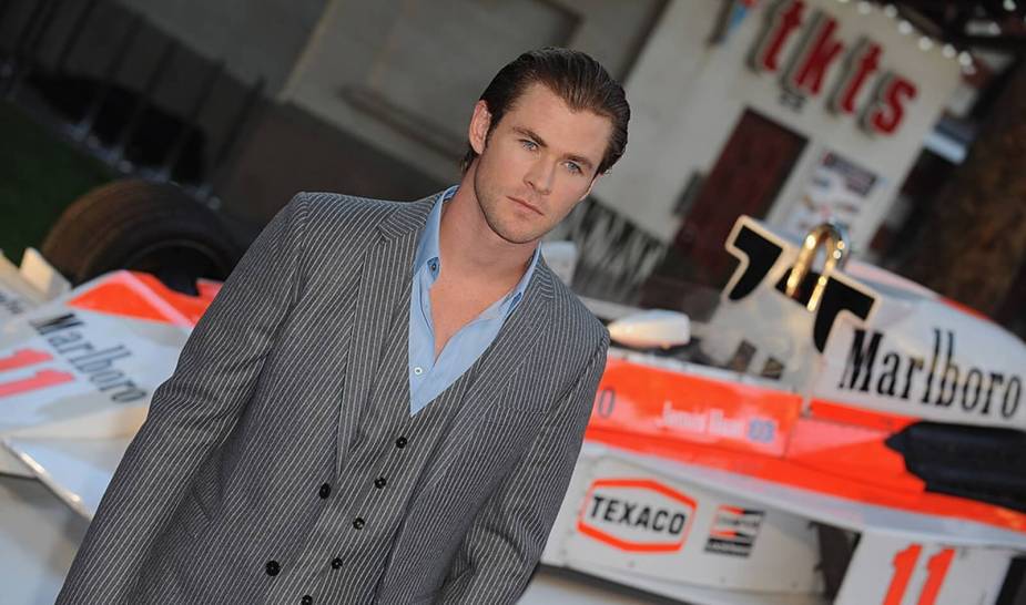 Chris Hemsworth poses next to a race car at the premier of the racing movie 'Rush'.