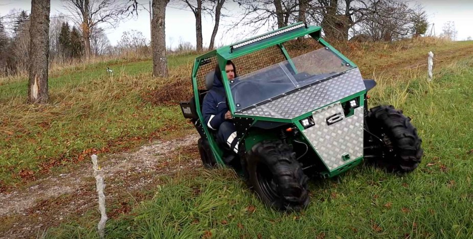 Homemade side-by-side UTV climbs a steep bank in the woods