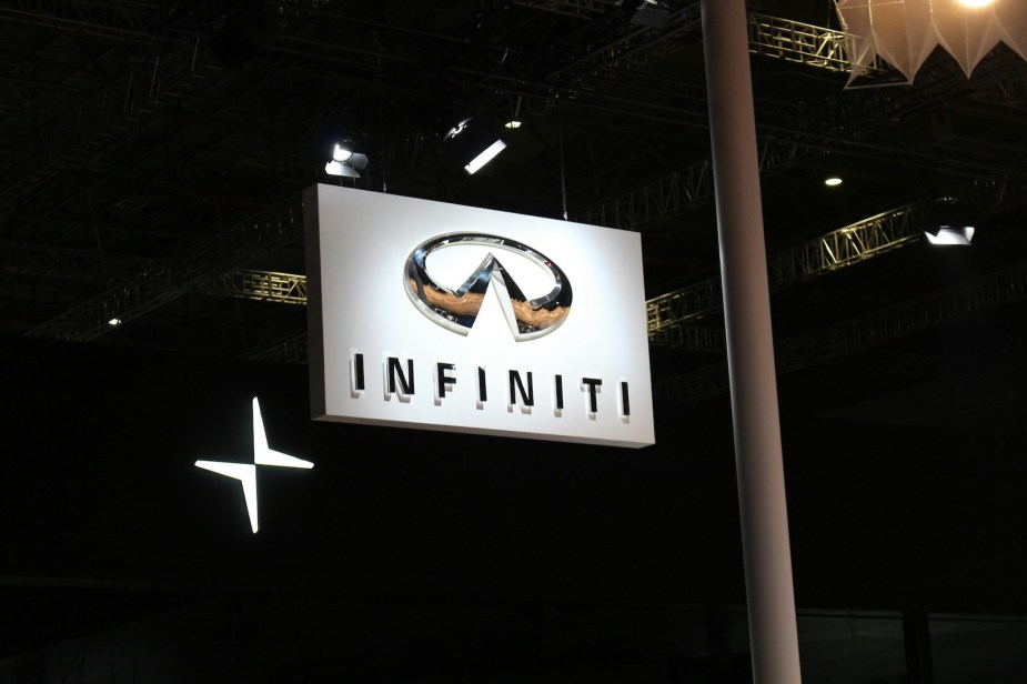 Infiniti car sign hanging above an automotive dealership.