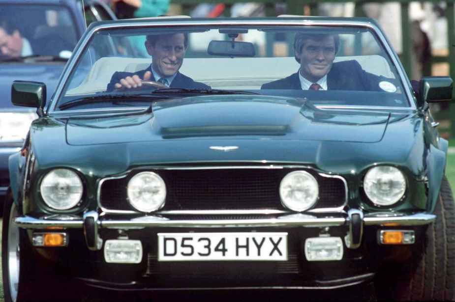 King Charles driving his gifted green Aston Martin V8 convertible with his body guard in 1988