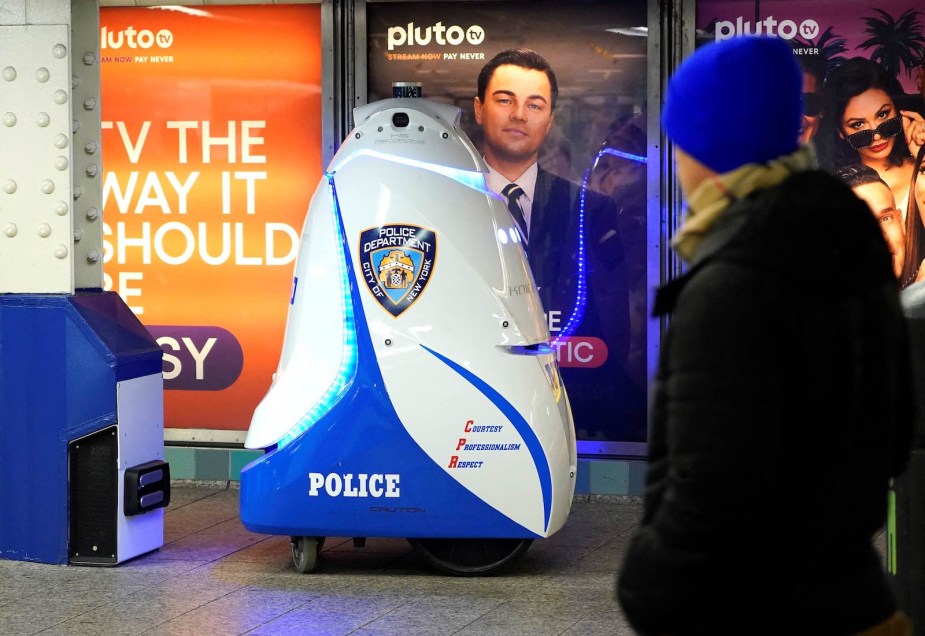 A knightscope K5 patrol robot in the NYC subway wearing NYPD police colors.