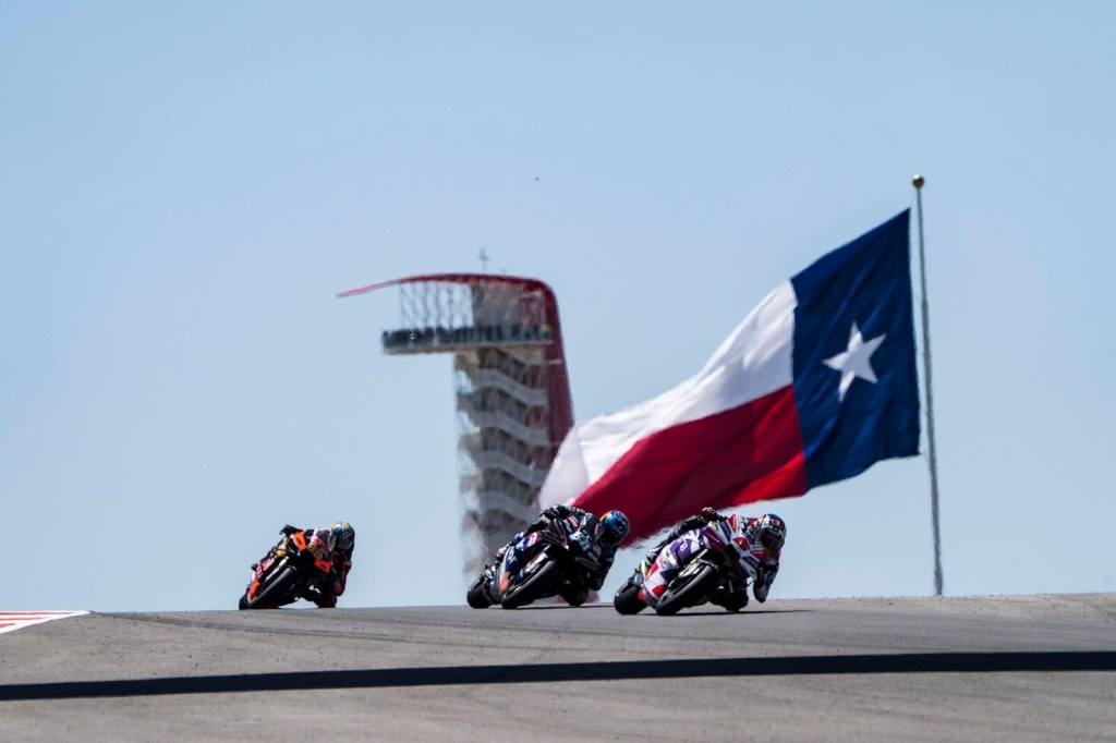 MotoGP racers crest a hill at the Circuit of the Americas.