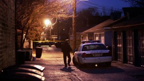 A police officer at a crime scene at night