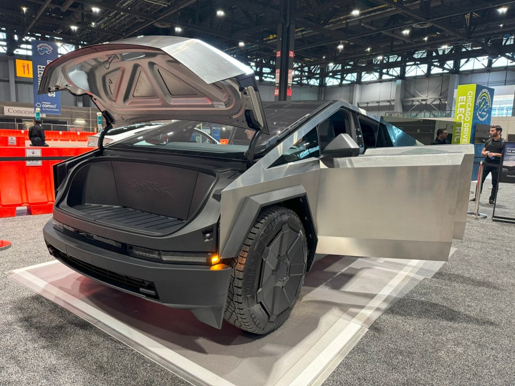 The Tesla Cybertruck with the hood and doors open