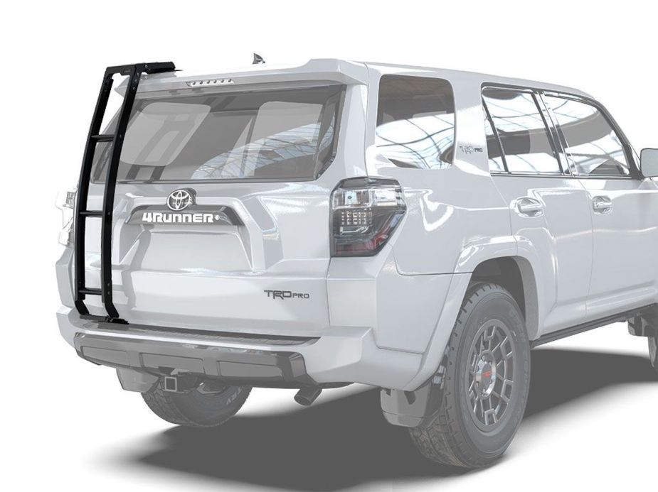 A white Toyota 4Runner TRD Pro SUV with an aftermarket ladder by Front Runner installed