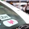 Uber and Lyft stickers on a windshield