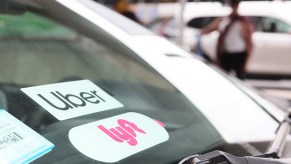 Uber and Lyft stickers on a windshield