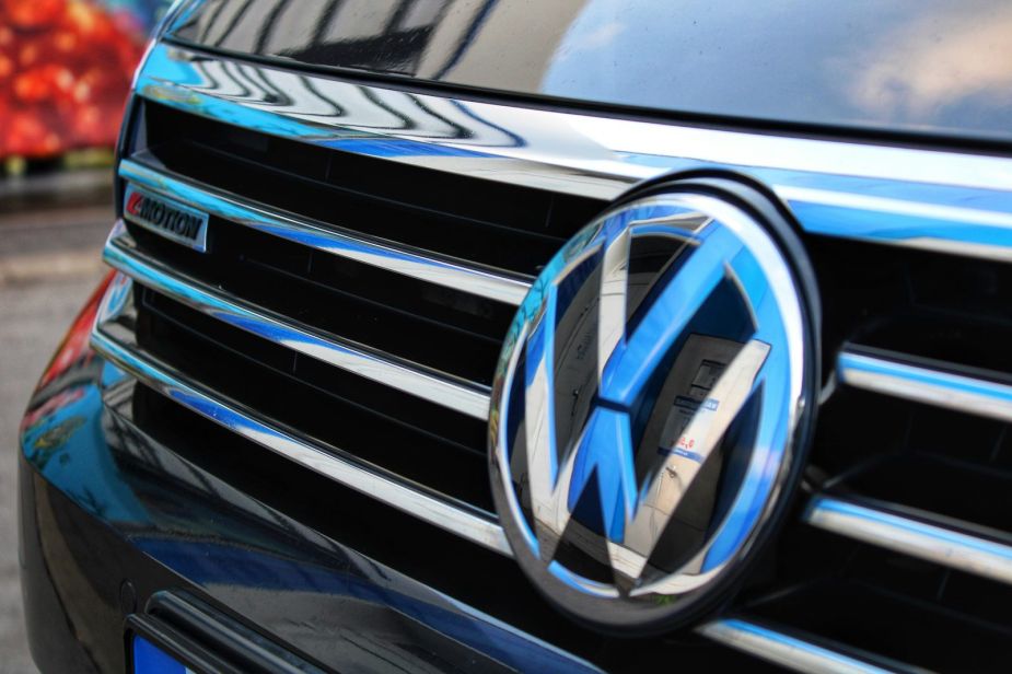 The Volkswagen logo on the grille of a VW car