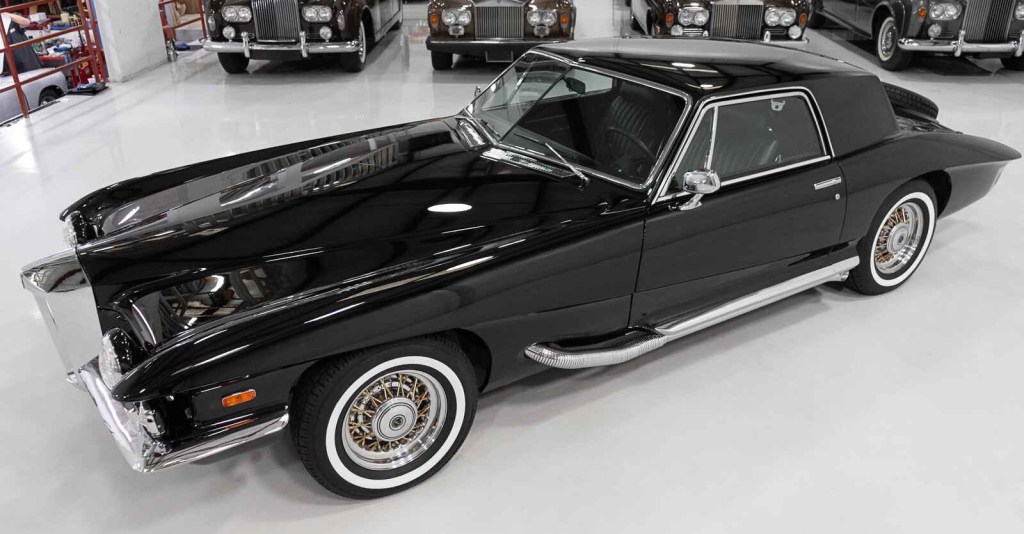 The black 1971 Stutz Blackhawk Series 1 Coupe owned by Elvis is parked at left front profile view