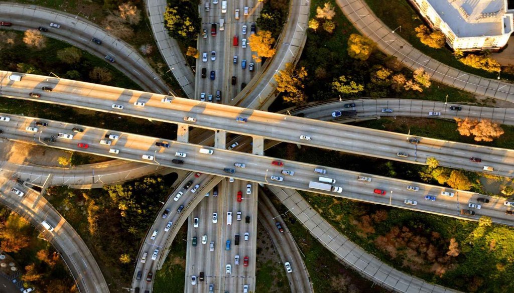 A close aerial view of LA's 'The Stack' Four-Level Freeway Interchange with cars