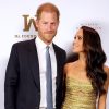 Meghan Markle and Prince Harry photographed attending an NYC event on May 16, 2023 a paparazzi police chase would follow Meghan wearing gold dress Harry in a suit with blue tie