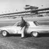 A photo of Bob James at the NASCAR Daytona 500 standing next to a stock 1963 Plymouth.
